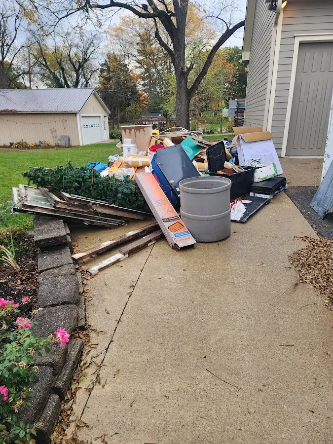 Dumpster being loaded with debris for Estate Cleanout Dumpster Rental in Piney Point Village